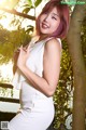A woman in a white dress posing for a picture.